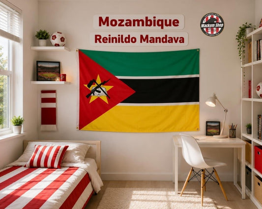 A bedroom scene with a large Mozambique flag hanging on the wall. Above it are two white signs reading 'Mozambique Reinildo Mandava' and a round 'Mockup Shop' logo.