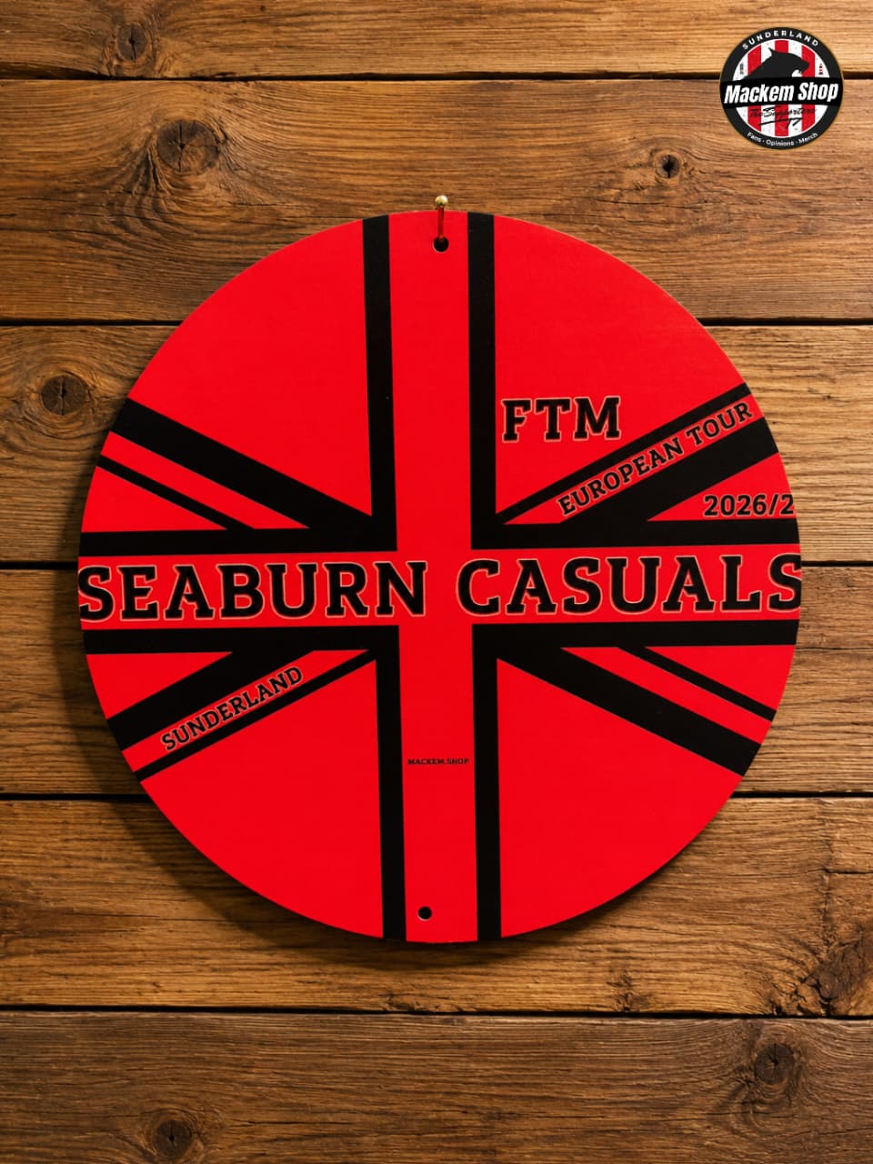 Circular metal sign with 'FTM Seaburn Casuals' design by MackemShop on a wooden background