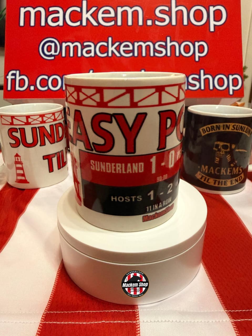 Mugs with sports-themed designs on a red and white checkered tablecloth, with 'mackem.shop' branding.