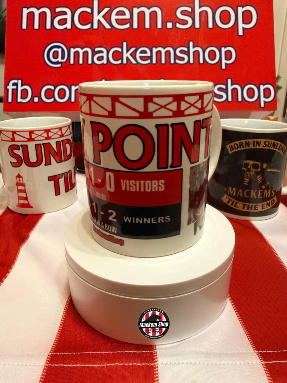 Mug with sports-themed design on a red and white checkered tablecloth, with 'mackem.shop' branding in the background.