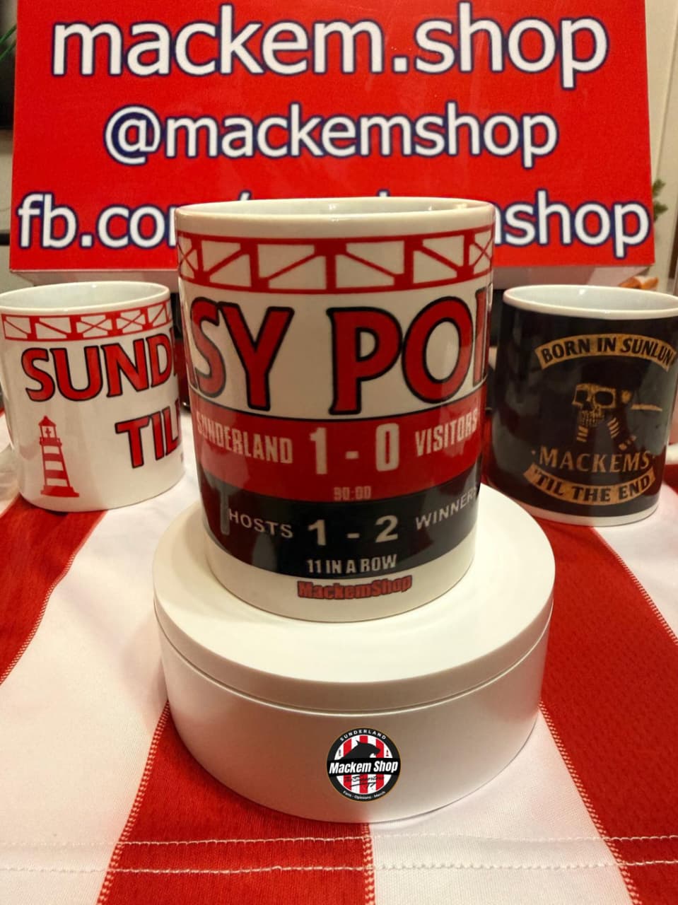 Mackem Shop branded mugs on a red and white checkered tablecloth with a visible logo.