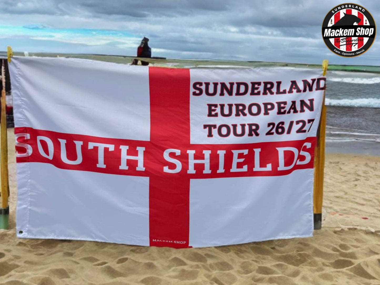 Flag with 'Sunderland European Tour 26/27 South Shields' text on a beach.