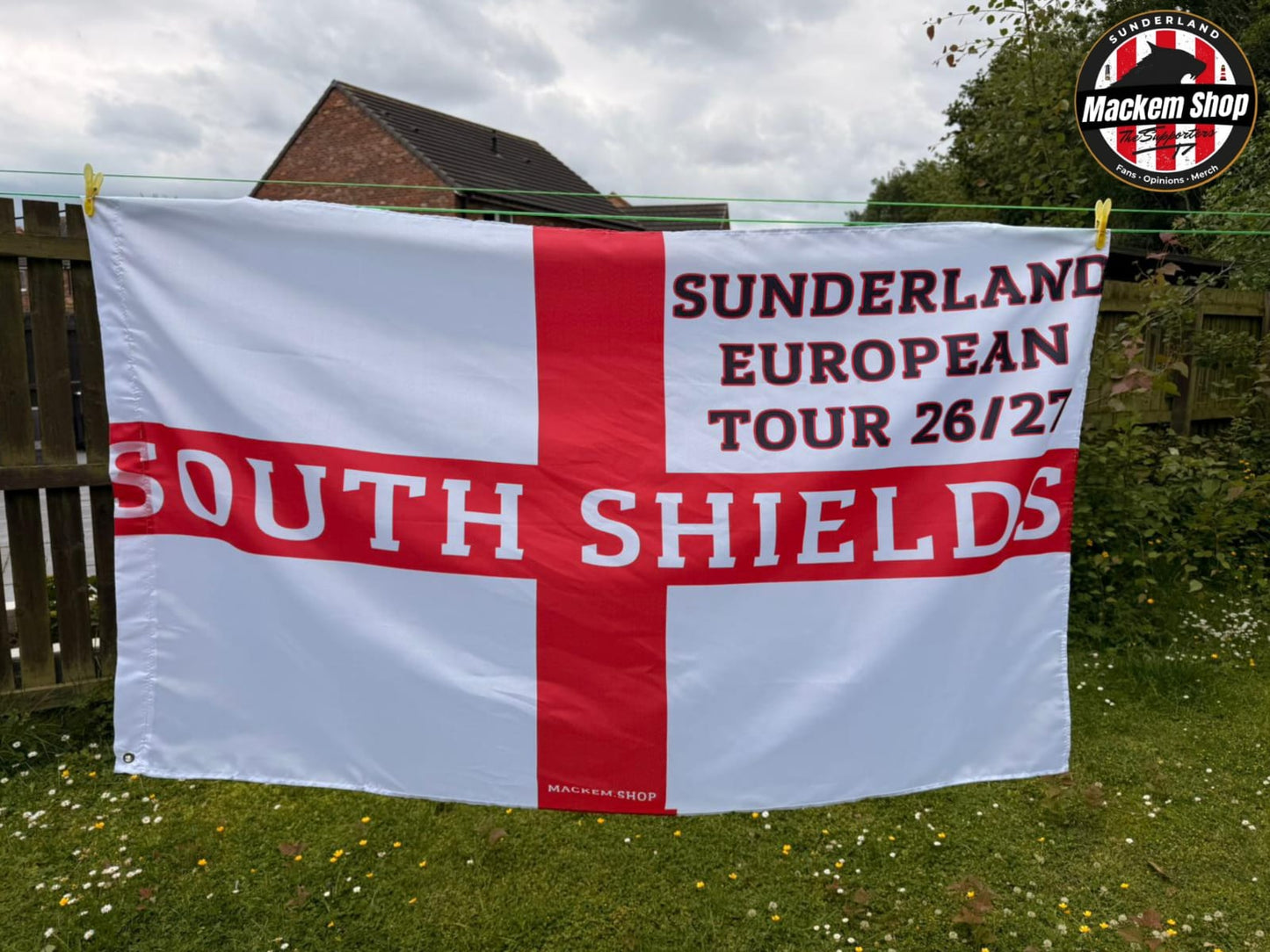 Flag with 'Sunderland European Tour 26/27 South Shields' text on a grassy background