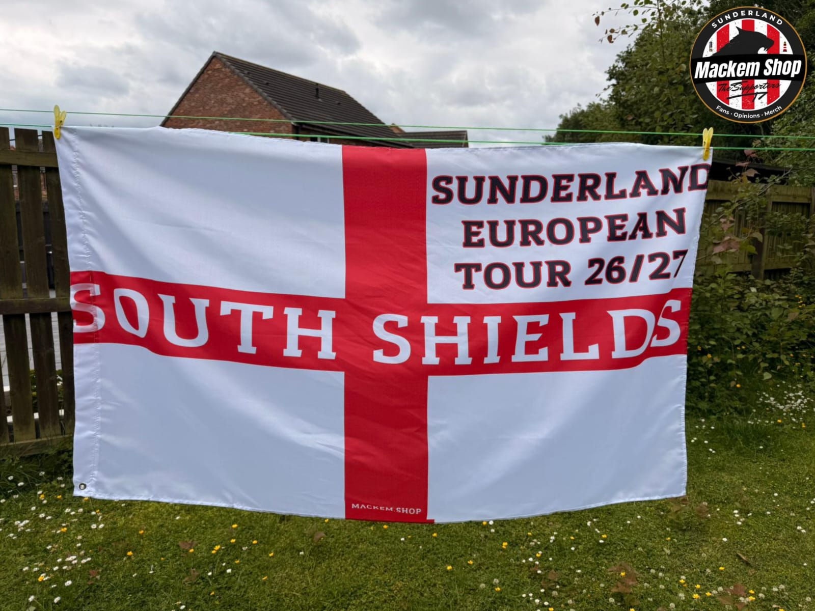 Flag with 'Sunderland European Tour 26/27 South Shields' text on a grassy background