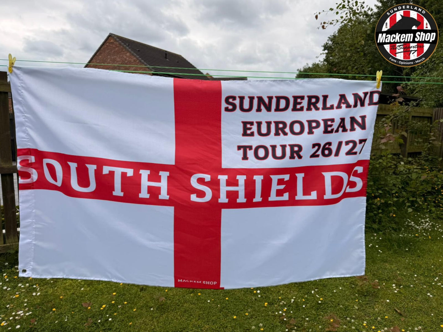 Flag with 'Sunderland European Tour 26/27 South Shields' text on a grassy background