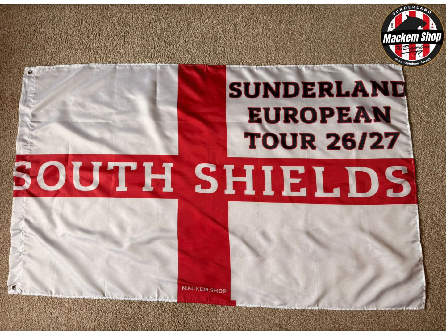 Flag with 'Sunderland European Tour 26/27 South Shields' text on a red and white cross background.