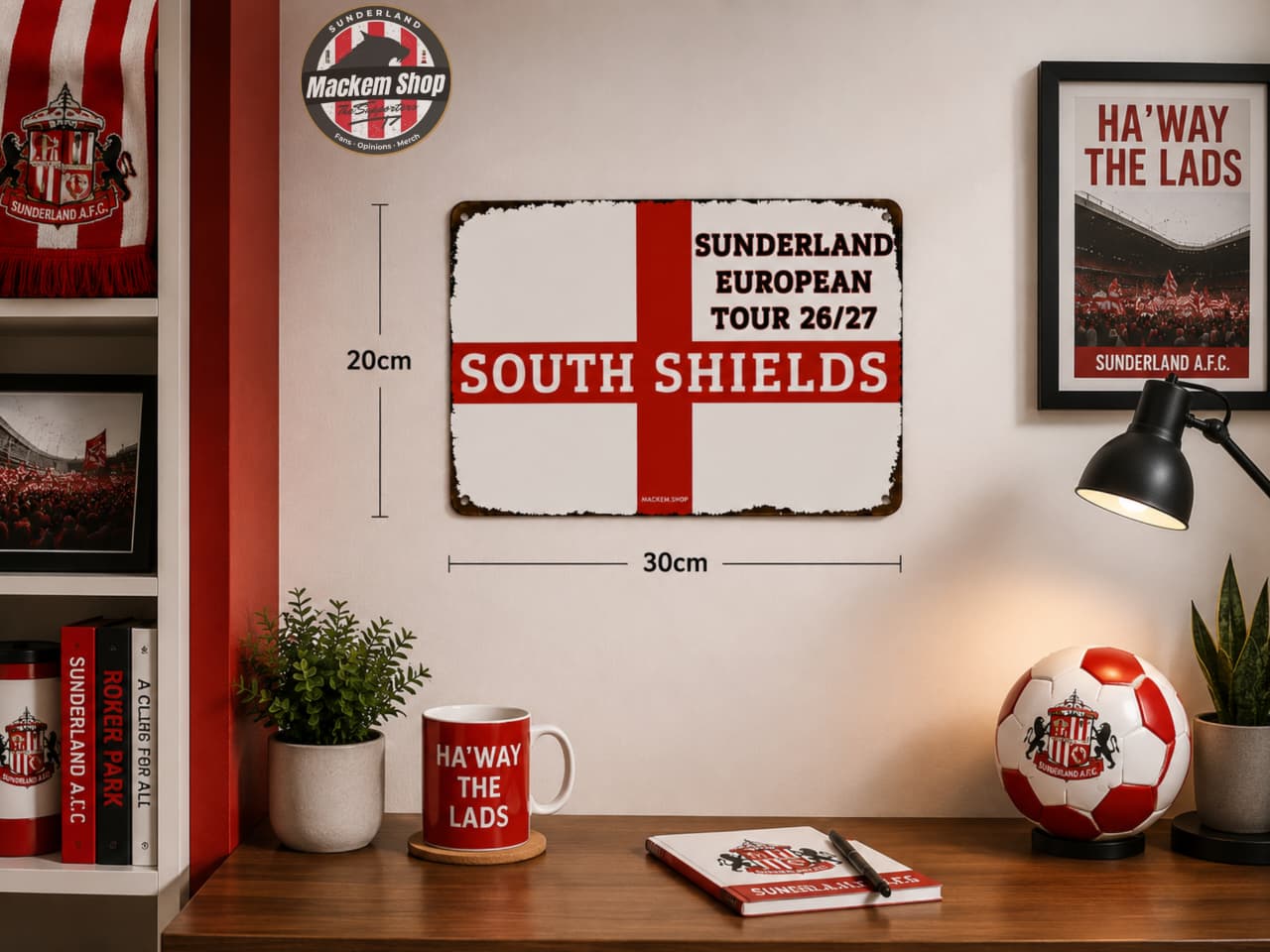 A rectangular metal-style Sunderland football club sign displayed on a wall in a styled room. The sign reads 'SUNDERLAND EUROPEAN TOUR 26/27' and 'SOUTH SHIELDS' with a red cross motif on a white background.