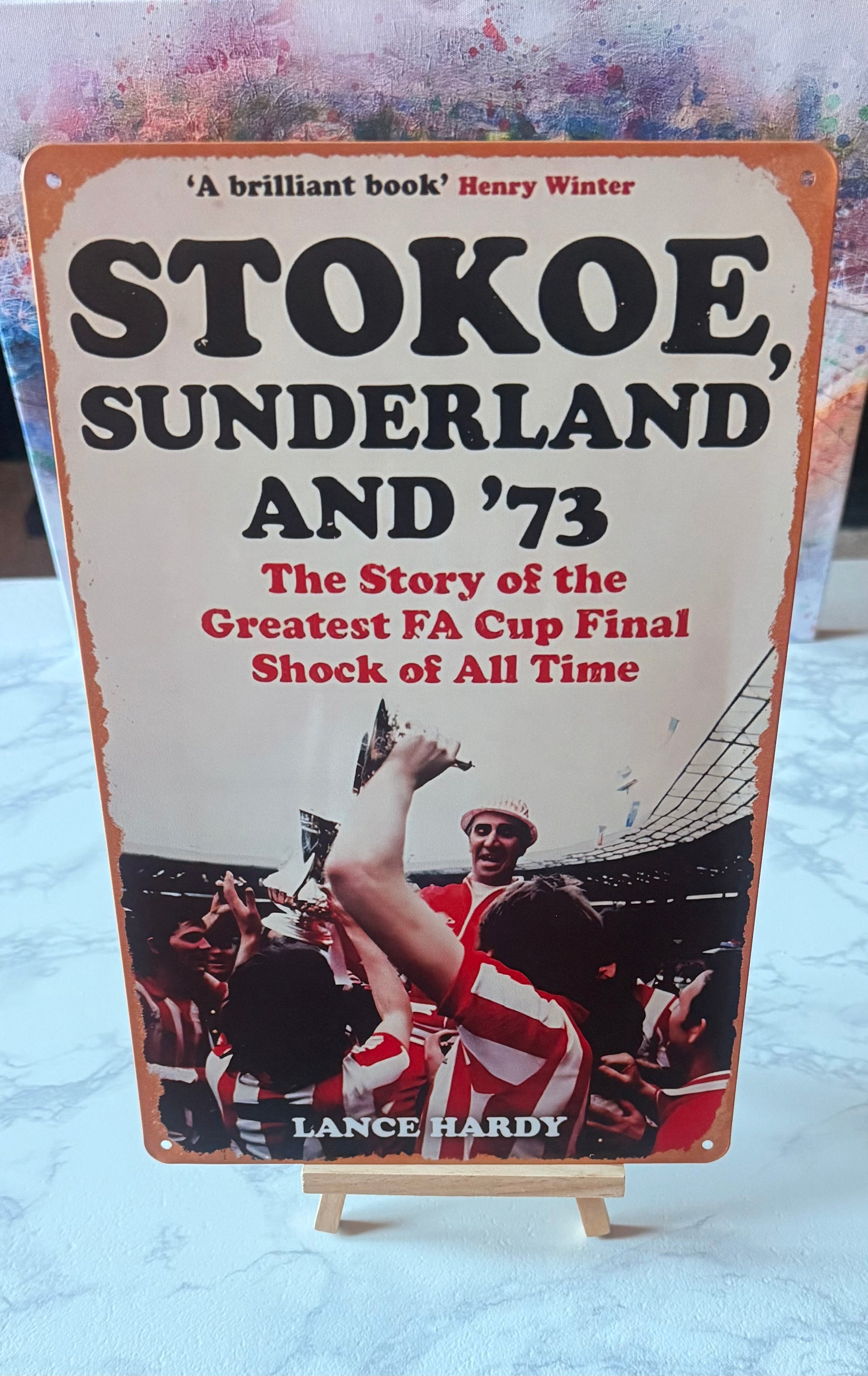 Book cover of 'Stokoe, Sunderland and '73' on a stand with a textured background