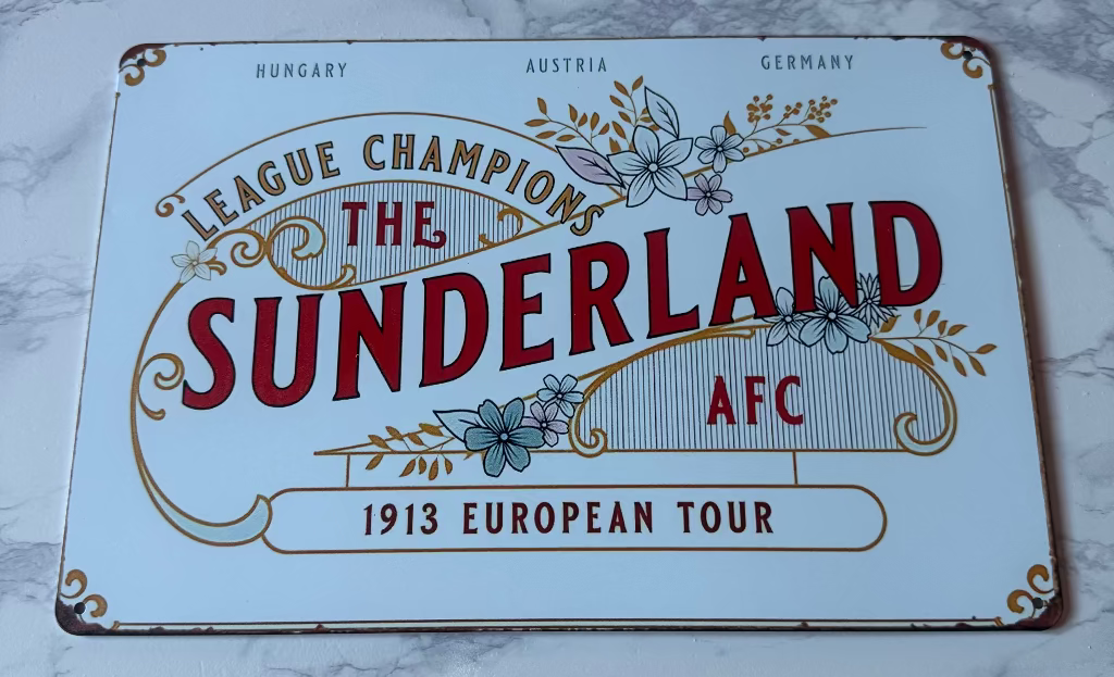 Vintage-style sign for Sunderland AFC with decorative elements on a marble surface