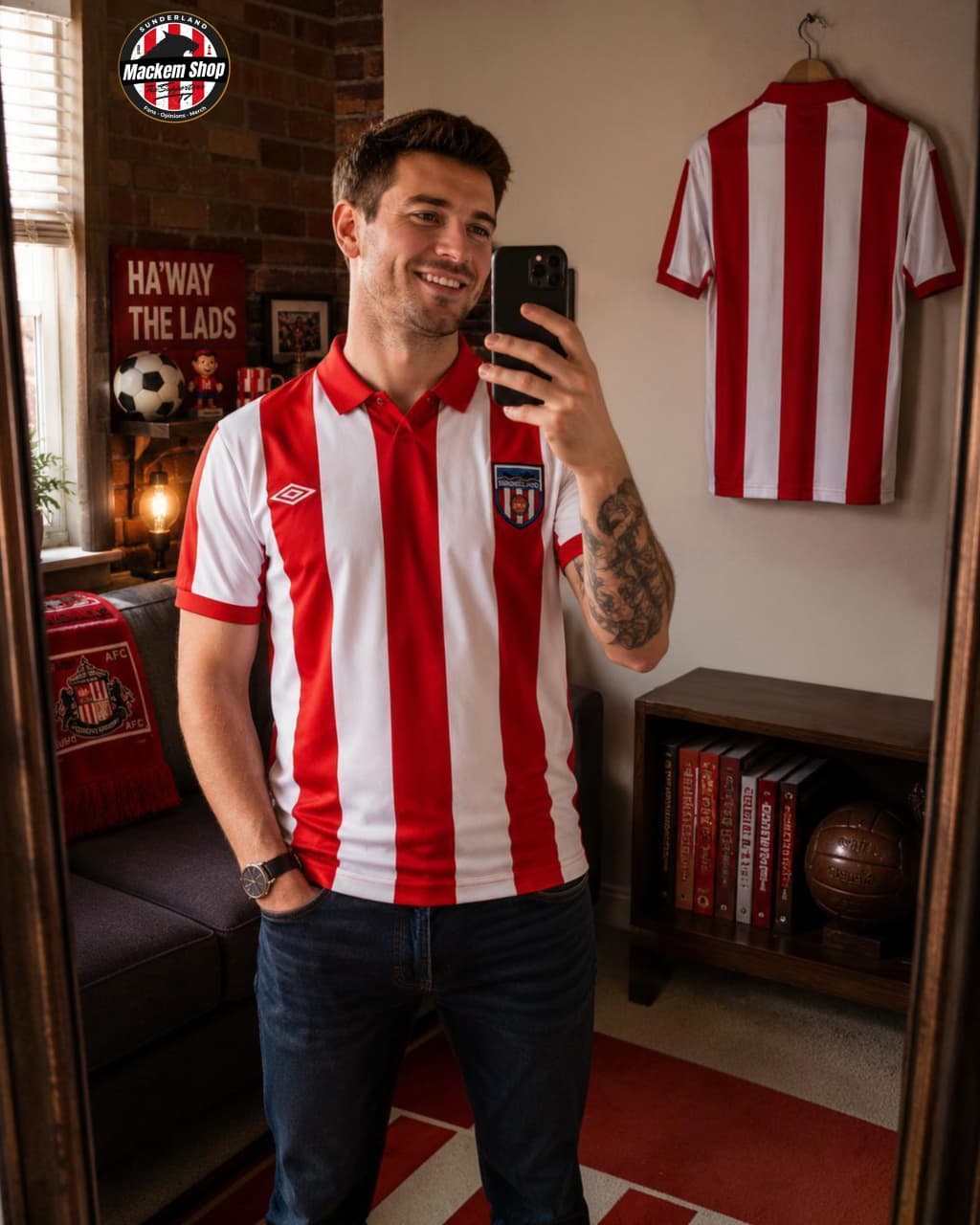 Man wearing a red and white striped shirt taking a selfie in a room with sports memorabilia.