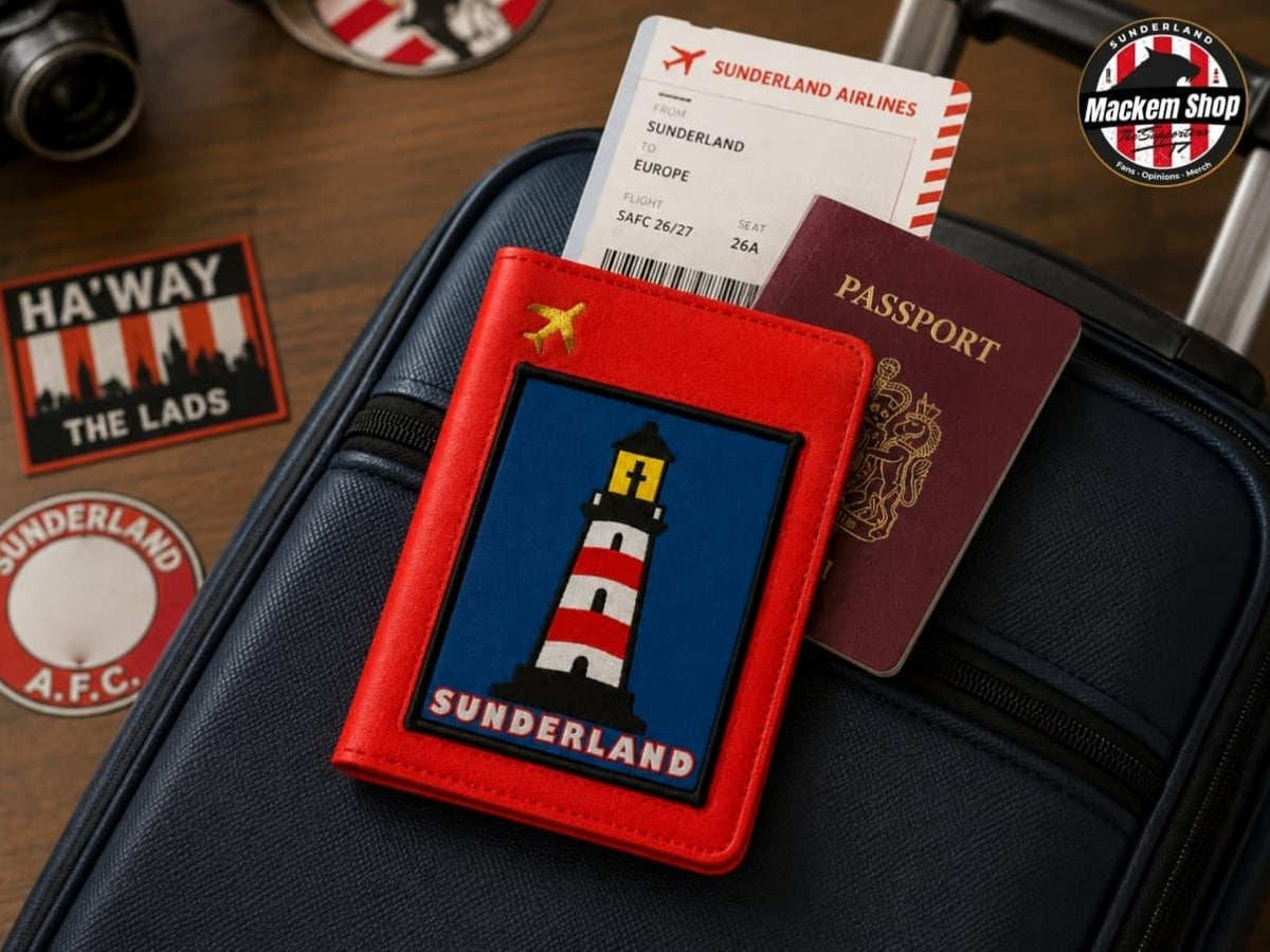 A red passport holder with a Sunderland-themed lighthouse patch, styled on a black suitcase with a boarding pass, a real passport, and travel stickers nearby.