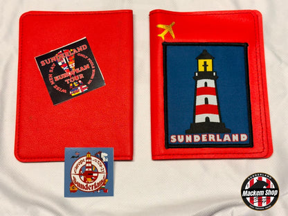Two red fabric Passport covers displayed on a white fabric background, each featuring a Sunderland-themed design. One shows a black square patch with red and white Sunderland text and imagery, and the other shows a blue square patch with a red-and-white lighthouse and the word 'SUNDERLAND.