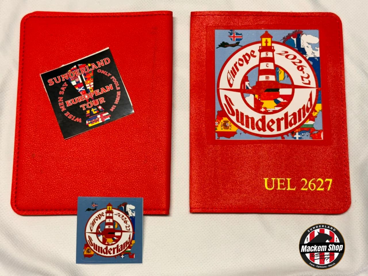A red Sunderland football-themed item, likely a sleeve or cover, shown from the front and back on a white fabric background. The front features a large circular Sunderland crest graphic with 'Europe 2026' and 'Sunderland' text, plus yellow 'UEL 2627' lettering.