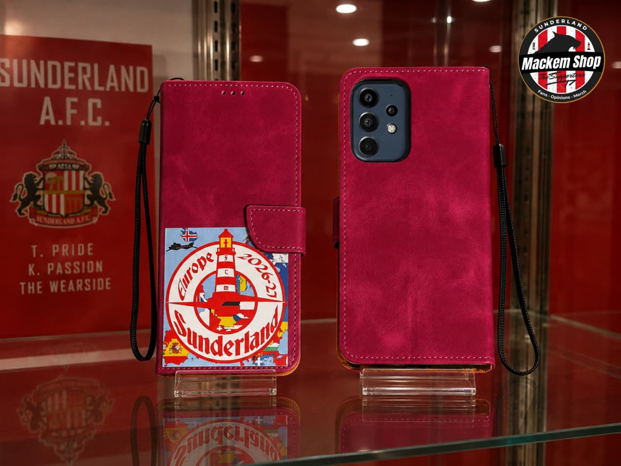 A magenta pink Samsung A53 phone wallet case shown from both front and back views on a glass display case. The front view features a Sunderland Europe 2026-27 tour patchwork with Lighthouse in it.
