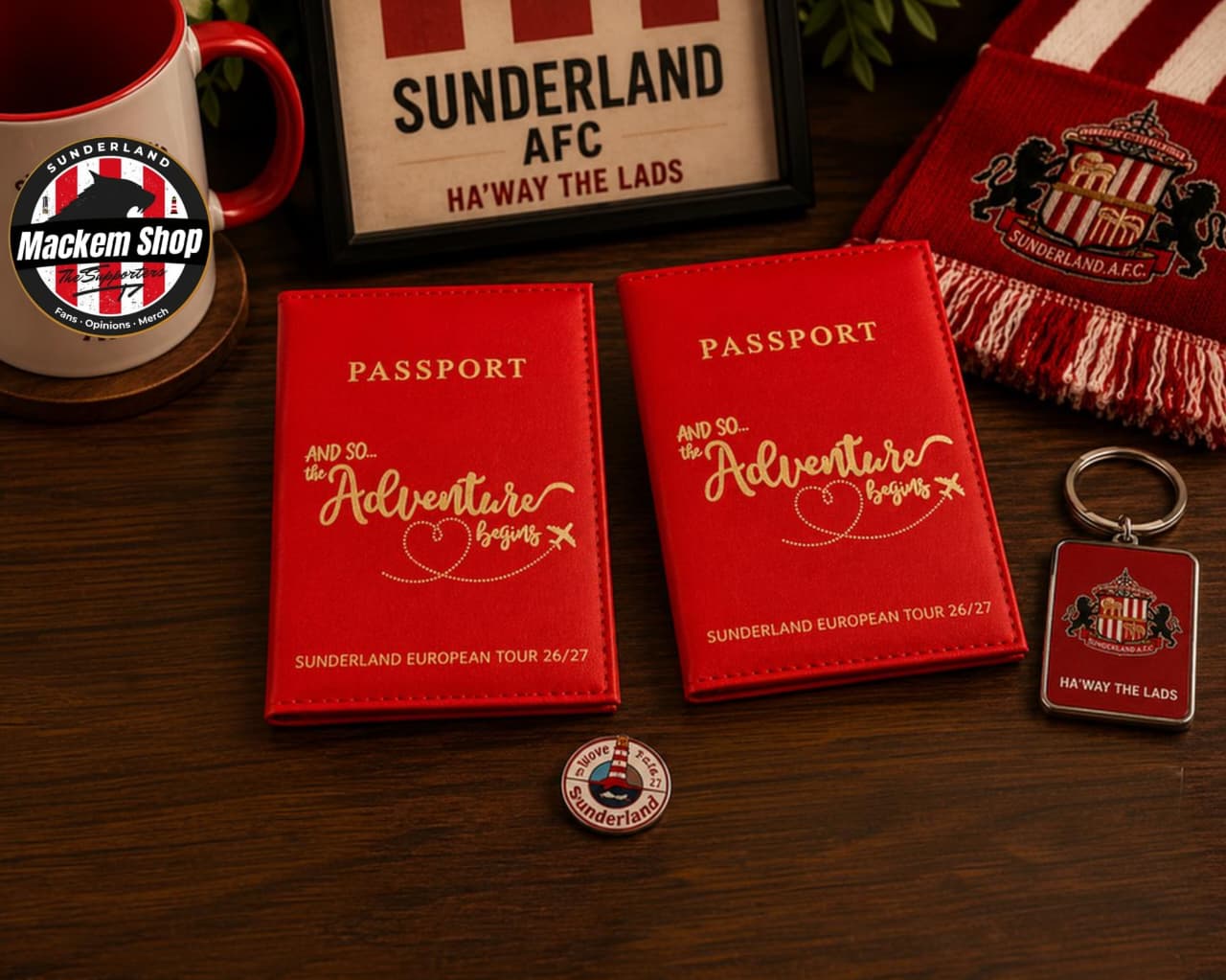 Two red Sunderland AFC passport-style holder mockups on a dark wooden table, surrounded by themed merchandise including a scarf, mug, badge, and keychain.