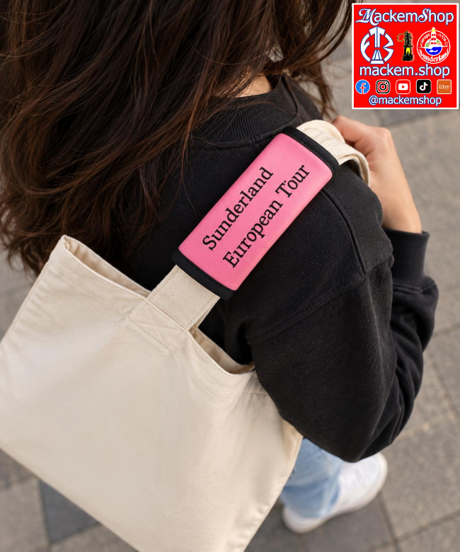 A person wearing a black sweatshirt carries a cream canvas tote bag over their shoulder. The bag has a bright pink rectangular patch on the strap with the text 'Sunderland European Tour' in black. A MackemShop Logo is visible on Top right corner.