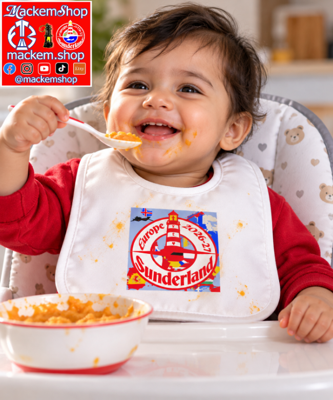 A baby wearing a white bib with a colorful 'Sunderland Europe' lighthouse graphic, sitting in a high chair and eating from a bowl. The background is a blurred indoor setting, and there is a 'MackemShop' logo overlay in the top left corner.