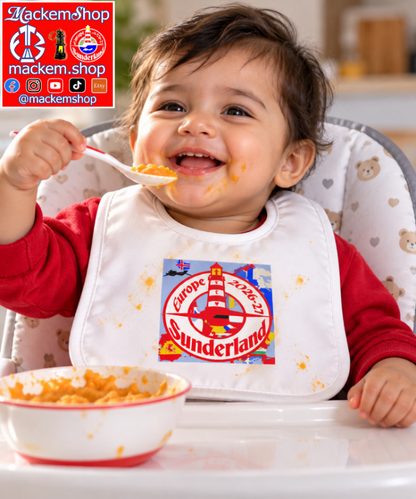 A baby wearing a white bib with a colorful 'Sunderland Europe' lighthouse graphic, sitting in a high chair and eating from a bowl. The background is a blurred indoor setting, and there is a 'MackemShop' logo overlay in the top left corner.