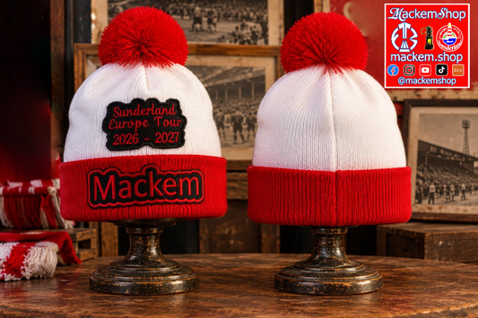Two white and red knit pom-pom beanies displayed on metal stands in a rustic indoor setting. One beanie has a black patch reading 'Sunderland Europe Tour 2026 - 2027' with a large red 'Mackem' patch on the cuff, and other one is the back portion of the same hat. A MackemShop Logo is visible on the top right corner.