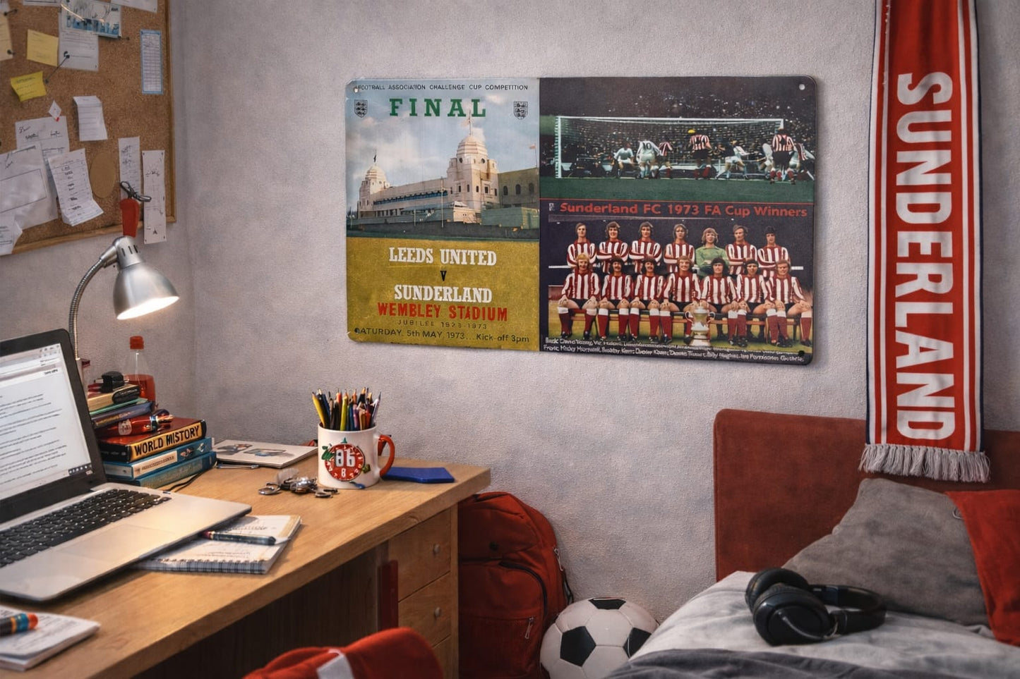 Room interior with a desk, laptop, and a Mackem shop sports memorabilia on the wall.