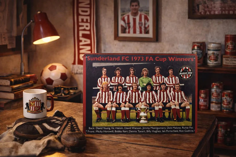 Sunderland FC 1973 FA Cup Winners Metal sign on a wooden table with sports memorabilia.