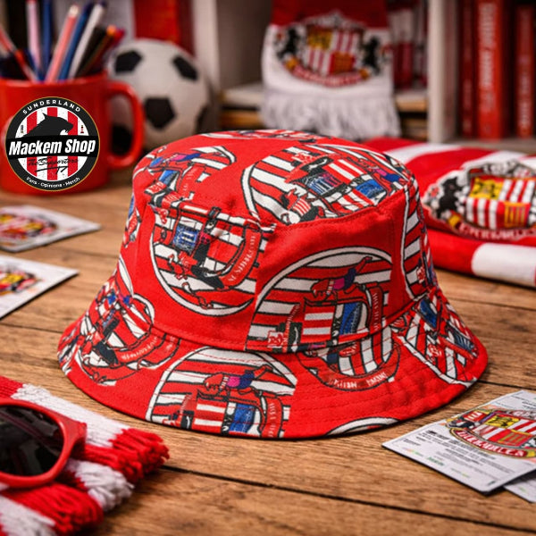 Red bucket hat with pattern on a wooden surface, surrounded by sports merchandise.