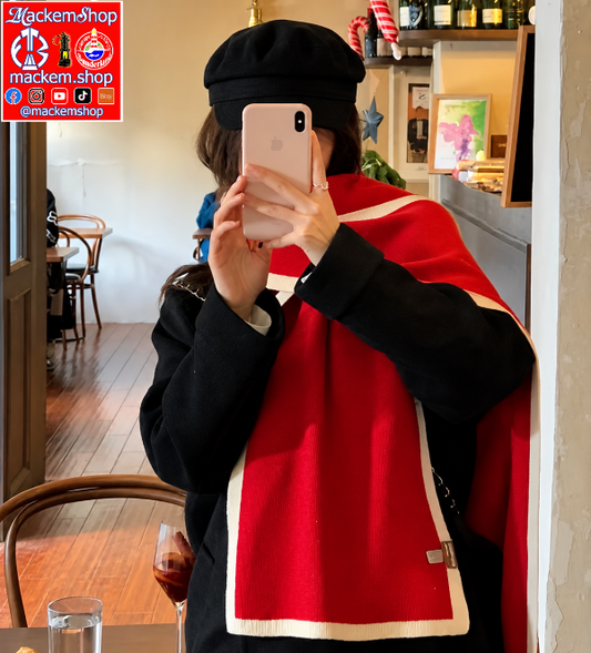 A Girl taking a mirror selfie in a cafe, wearing a black beret, a black coat, and a bright red scarf with cream trim. A logo overlay for 'mackemshop' is visible in the top left corner.