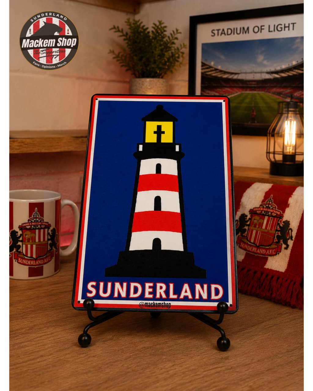 Sunderland-themed decorative sign with a lighthouse design on a wooden surface.