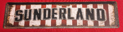 Decorative sign with 'SUNDERLAND' text on a red background