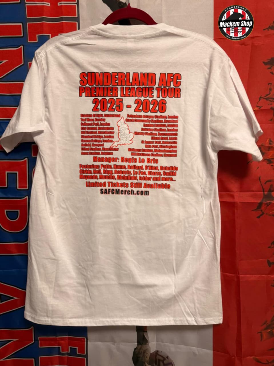 White t-shirt with red text on the back, displayed against a colorful background.