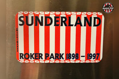 Sunderland sign with red and white stripes and text on a metallic surface