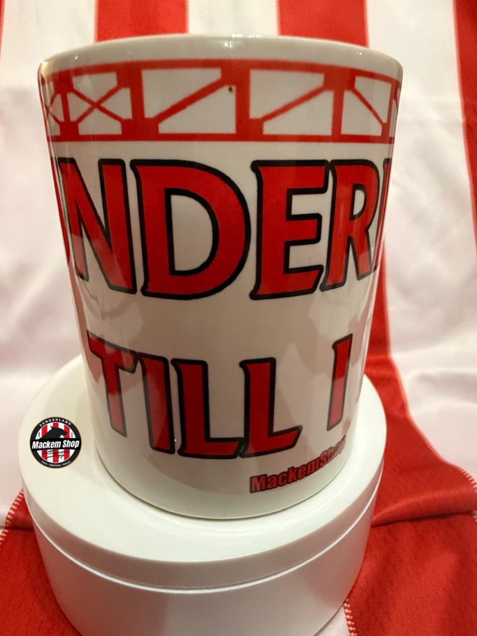 White mug with red text on a white and red striped background