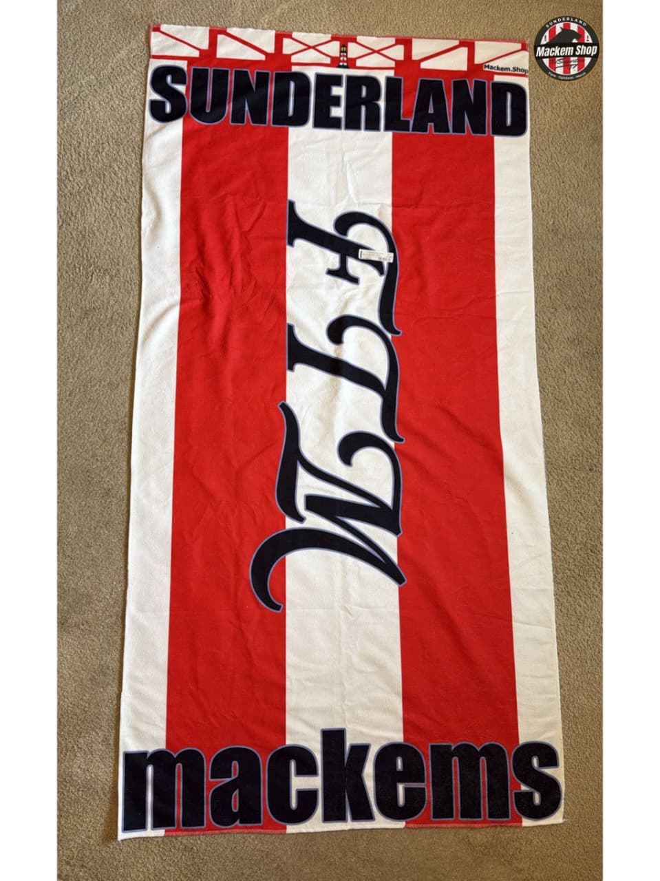 Red and white striped towel with 'Sunderland' and 'mackems' text on a beige background
