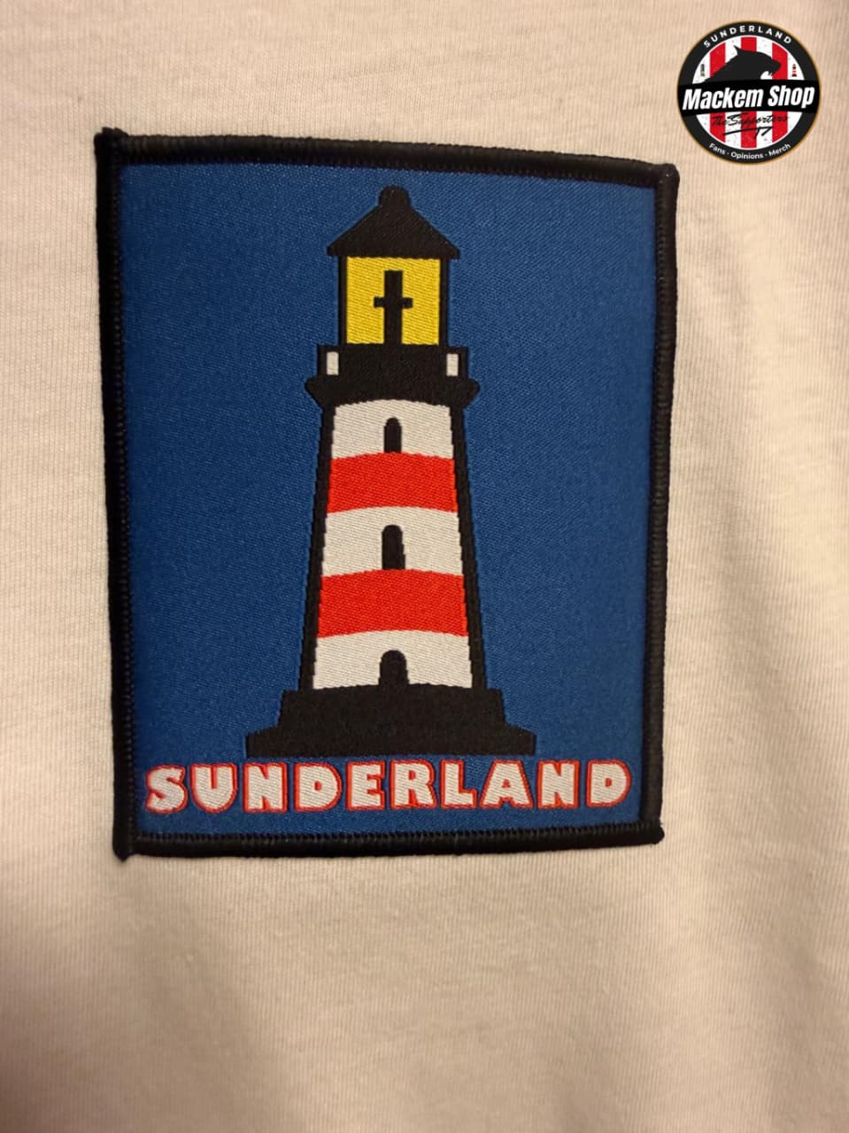 Patch of a lighthouse with 'Sunderland' text on a beige background, featuring the Mackem Shop logo.