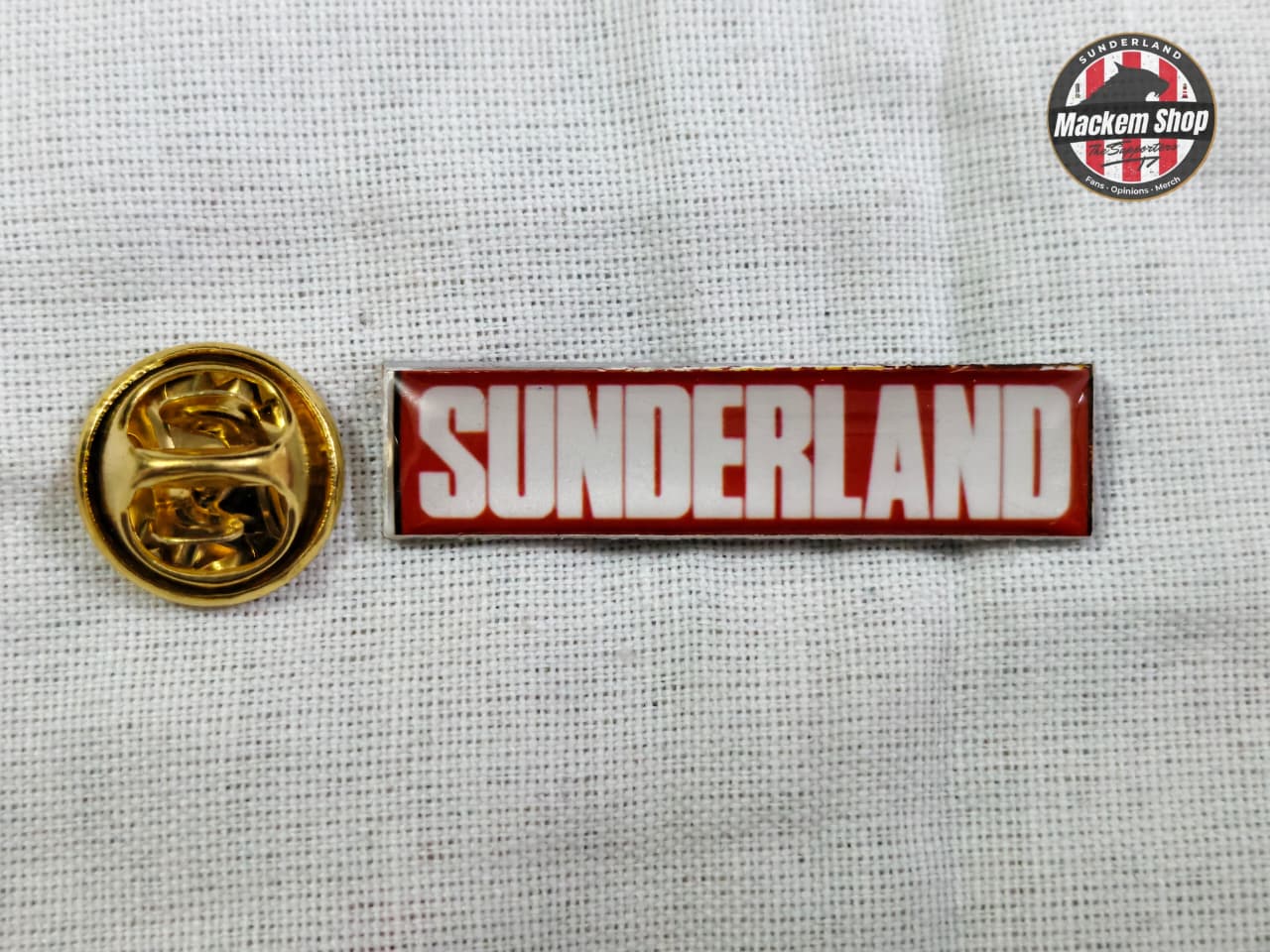 Sunderland badge with gold emblem on a textured white background
