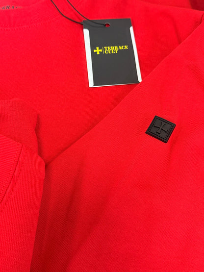 Red fabric with a black tag featuring a logo and text.