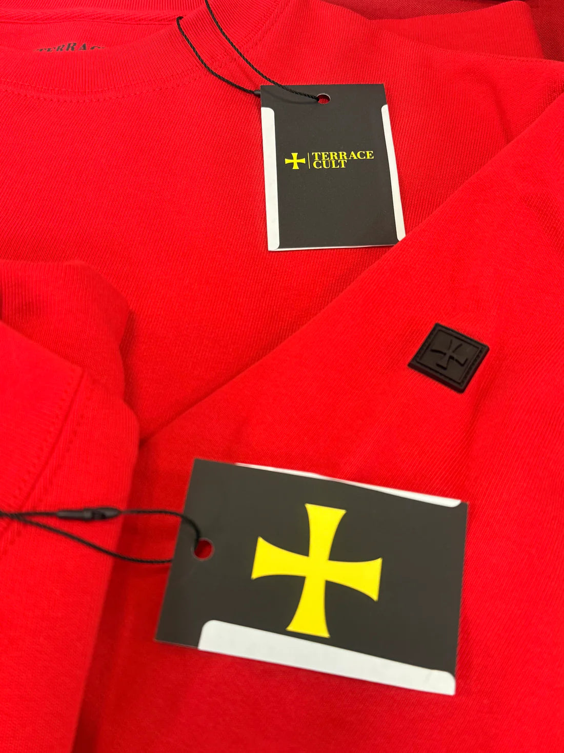 Red Sweatshirt with Terence Green tags featuring a yellow cross design.