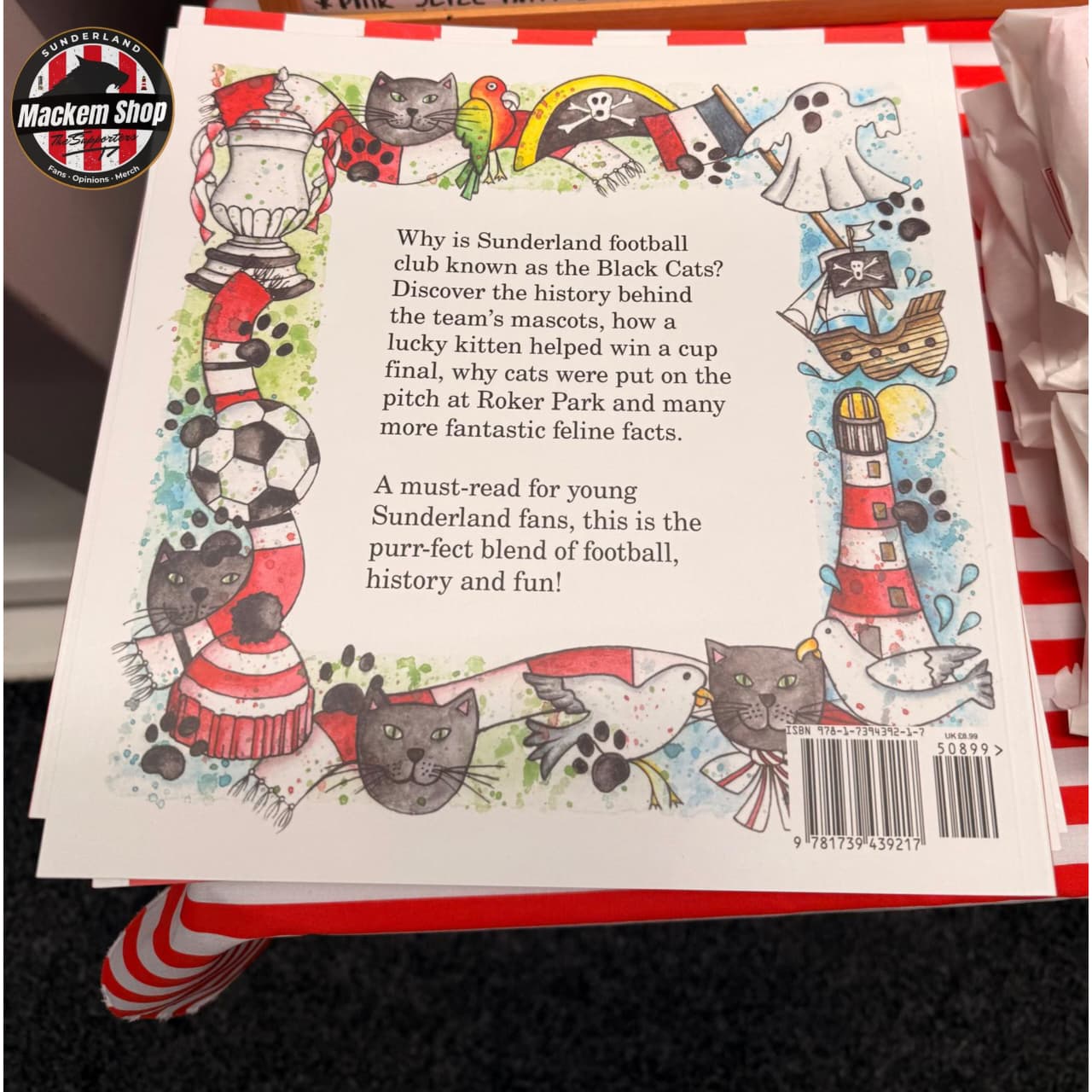 Book page with illustrations of cats and text about Sunderland football club's mascots.