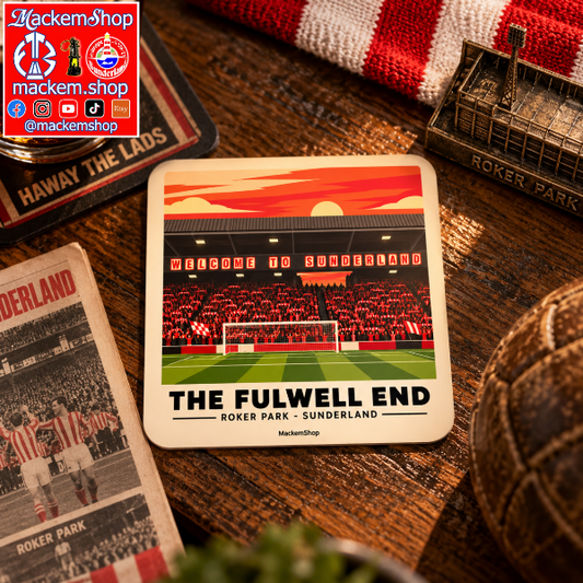 A square coaster featuring a stylized illustration of Roker Park stadium during sunset, with the text 'THE FULWELL END' and 'ROKER PARK - SUNDERLAND'. The coaster is displayed on a wooden table surrounded by football-themed items, including a red and white striped scarf, a vintage match card, and a miniature Roker Park building model.