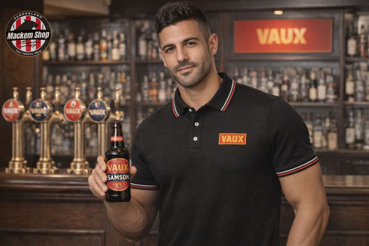 Man holding a Vaux beer bottle while wearing a VAUX polo shirt in a bar setting