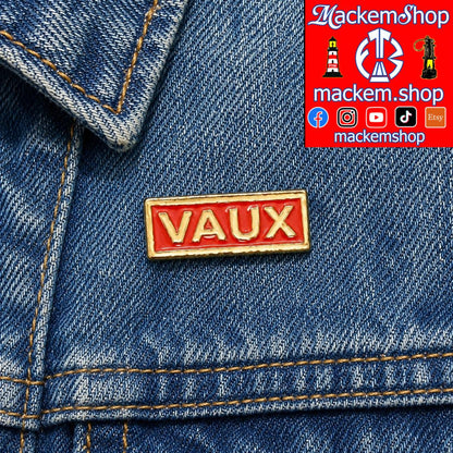 Red 'VAUX' pin on blue denim fabric with Mackem Shop branding.