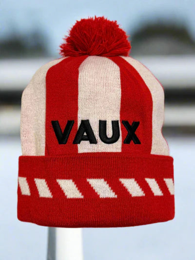 Red and beige striped beanie with 'VAUX' branding on a blurred background by MackemShop.