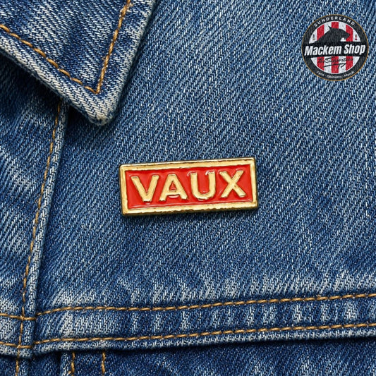 Red 'VAUX' pin on a blue denim jacket with a Mackem Shop logo in the corner.