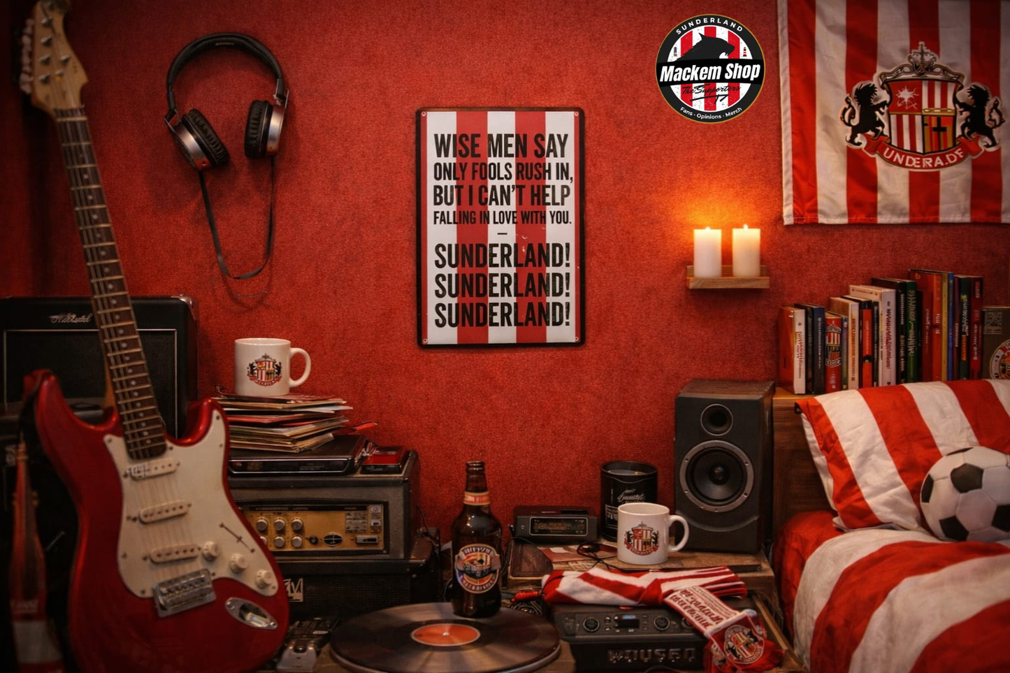 Room interior with red walls, guitar, books, and a Wise men say metal sign on the wall.