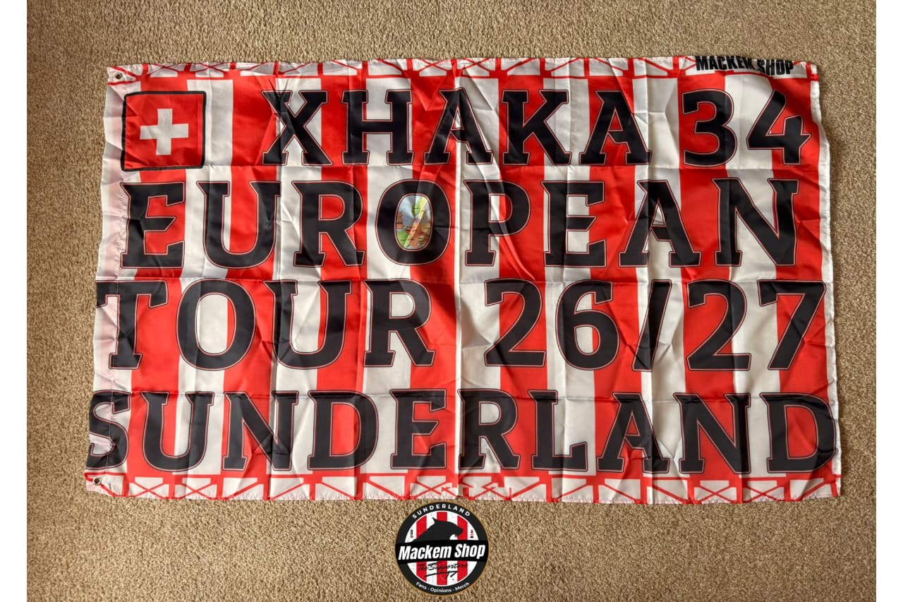 Flag with text 'Xhaka 34 European Tour 26/27 Sunderland' on a red and white striped background.