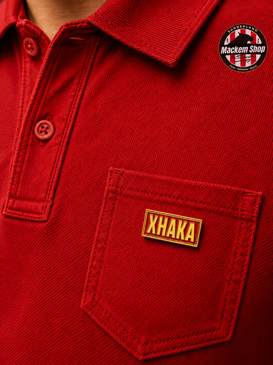 Red polo shirt with 'Xhaka' Badge on pocket and 'Mackem Shop'.