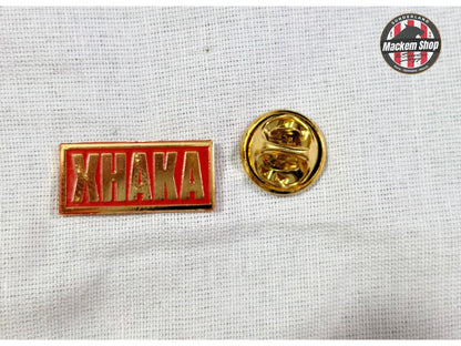 Yellow and red 'KHAKA' lapel pin on a textured white background with 'MackemShop' logo.
