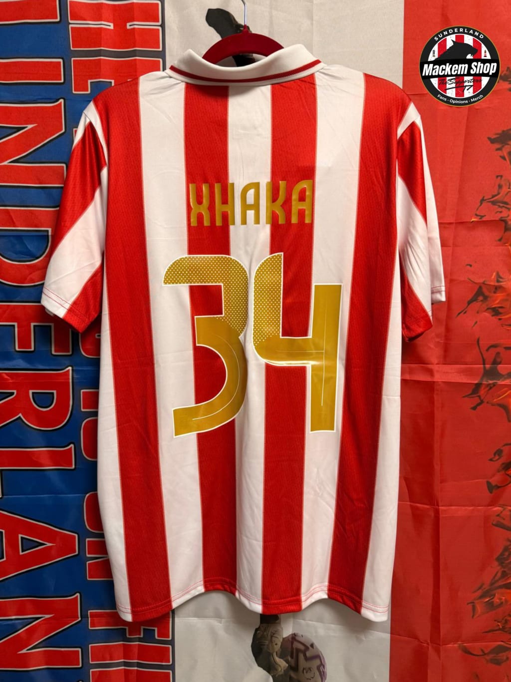 Red and white striped sports jersey with 'XHAKA' and number '34' on a colorful background