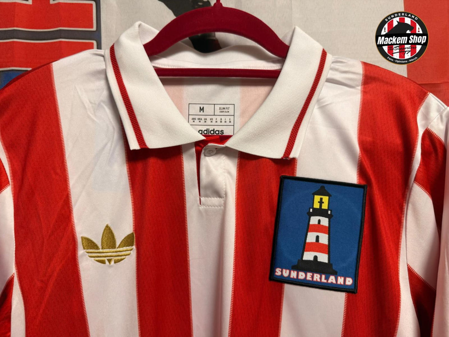 Red and white striped sports jersey with a Sunderland badge on a hanger.