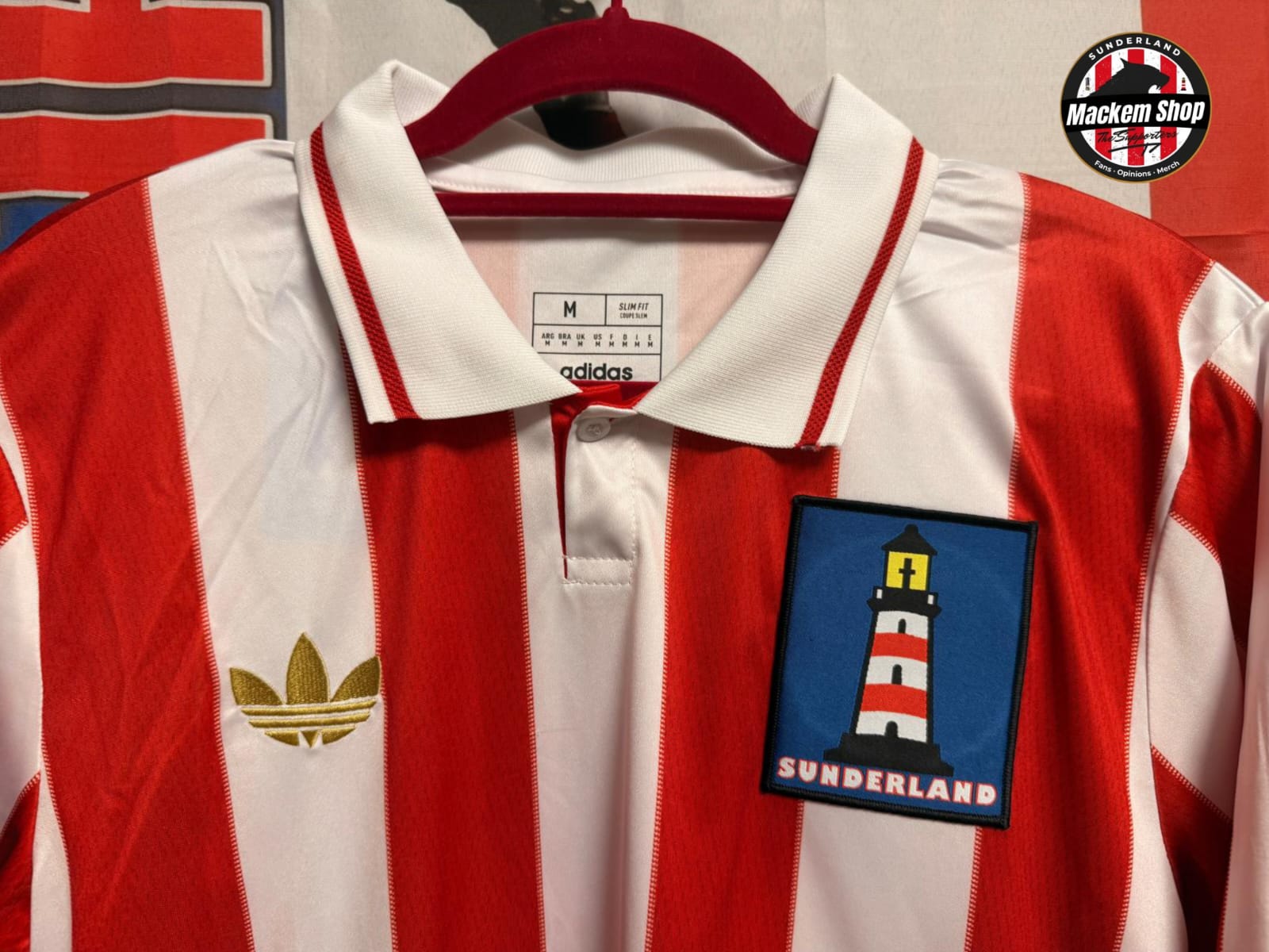Red and white striped sports jersey with a Sunderland badge on a hanger.